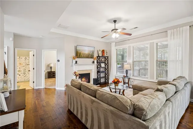 a living room with furniture a fireplace and a flat screen tv