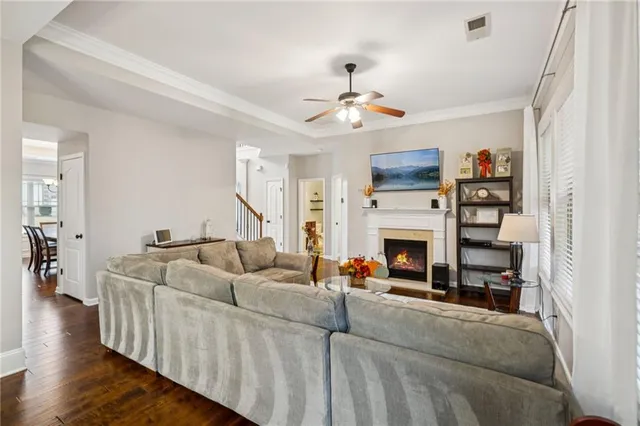 a view of a dining room and livingroom with furniture wooden floor a chandelier