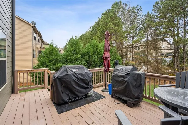 a bathroom with a granite countertop sink a toilet and shower curtain