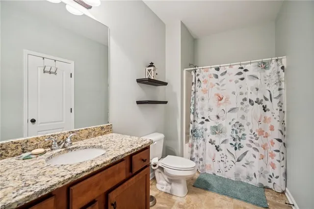 a bedroom with furniture a flat screen tv and a window