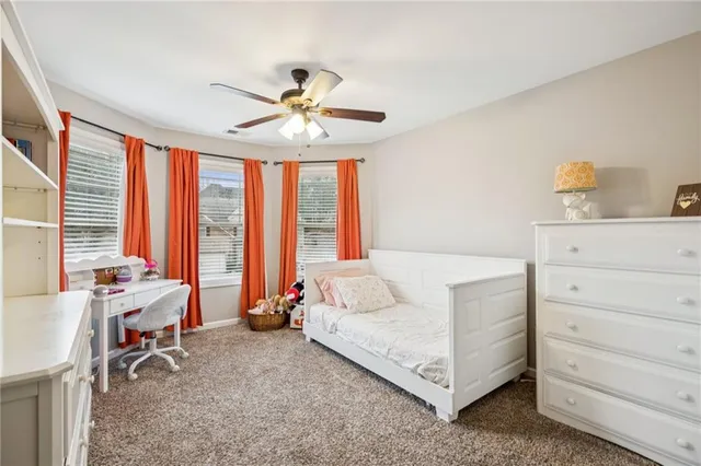a view of a living room hardwood floor and a ceiling fan