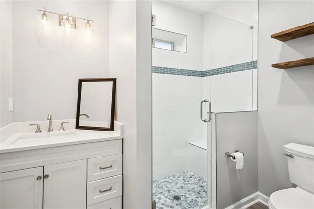 a backyard of a house with fire pit and chairs