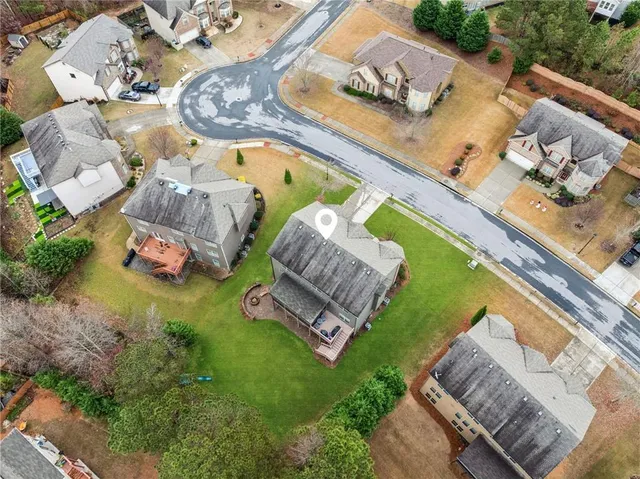 a view of a house with backyard and sitting area