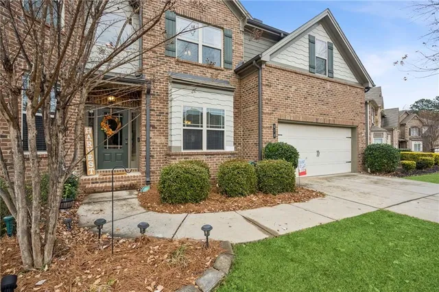 a view of staircase with lots of frames on wall and a window