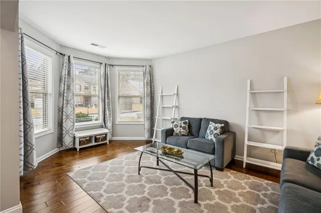 a view of a dining room with furniture a chandelier and wooden floor