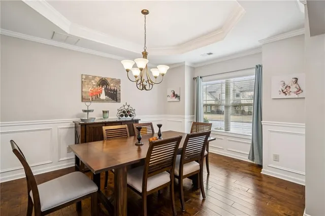 a living room with furniture wooden floor and a large window