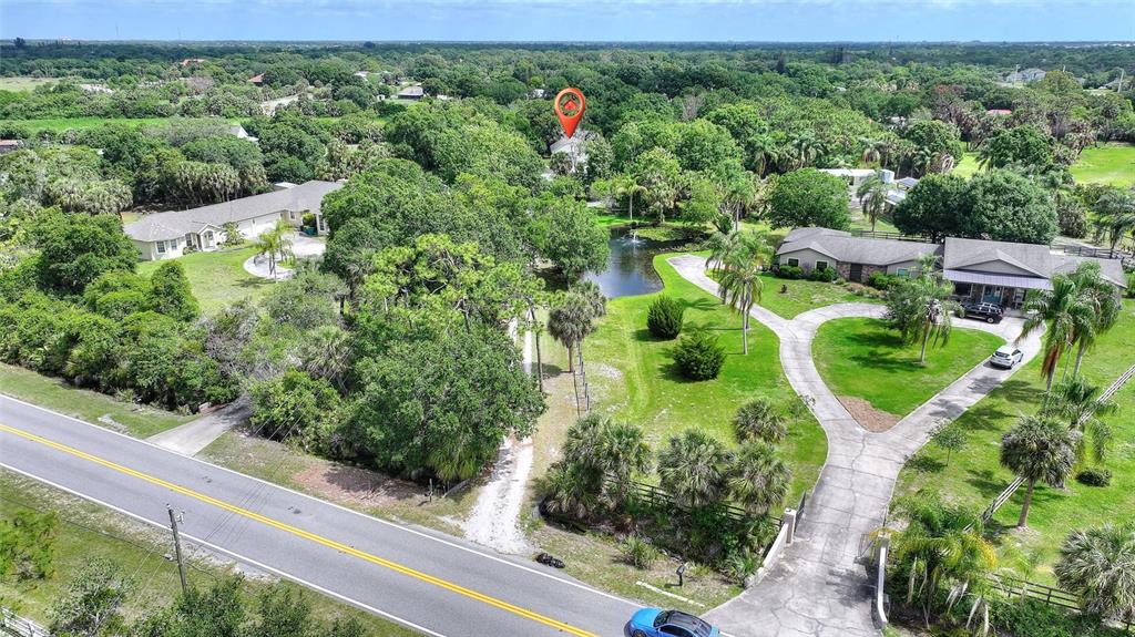 3641 Turtle Mound Road Melbourne, FL 32934 - Photo 59 of 77 an aerial view of a house with a garden