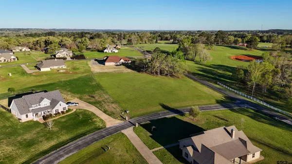 an aerial view of a houses with a yard