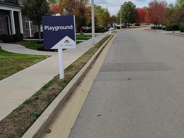 a view of a street with a park