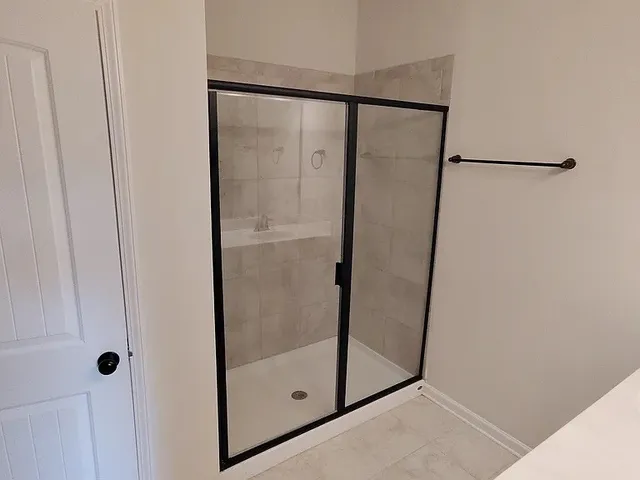 a bathroom with a glass shower door