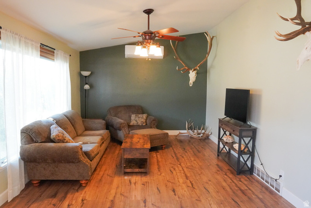324 Stringtown Road Georgetown, ID 83239 - Photo 6 of 49 Living area featuring lofted ceiling, a ceiling fan, and wood-type flooring