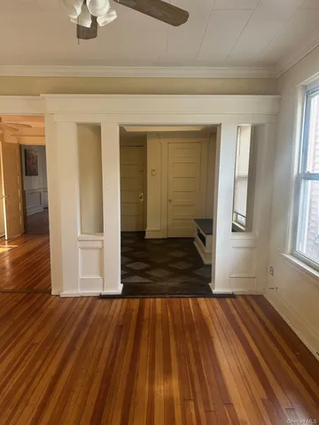 wooden floor in an empty room with a window