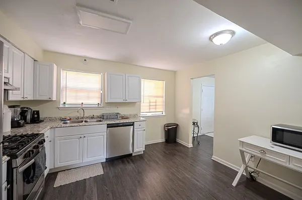 a kitchen with a sink stove and cabinets