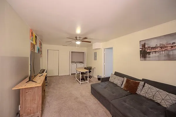 a living room with furniture and a chandelier