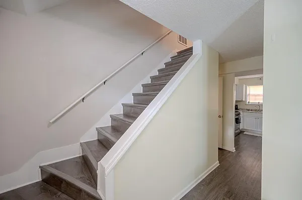 a view of entryway and hall with wooden floor