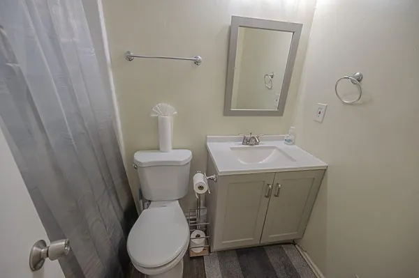 a bathroom with a toilet sink and mirror
