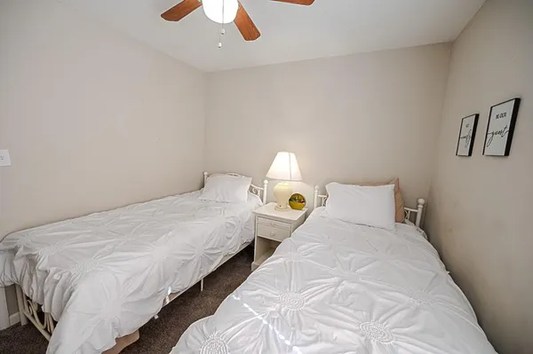 a bed room with two bed and a chandelier