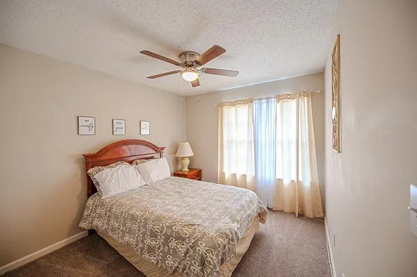a bedroom with a bed and window