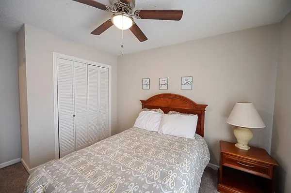 a bedroom with a bed and a lamp