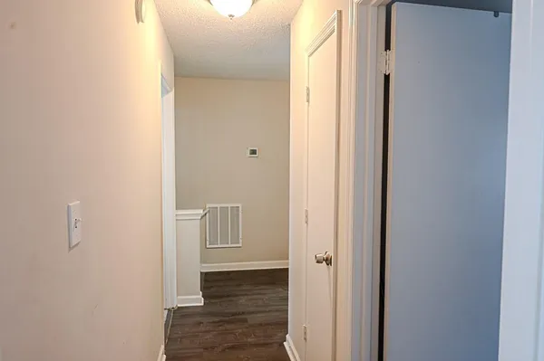 a view of room with wooden floor