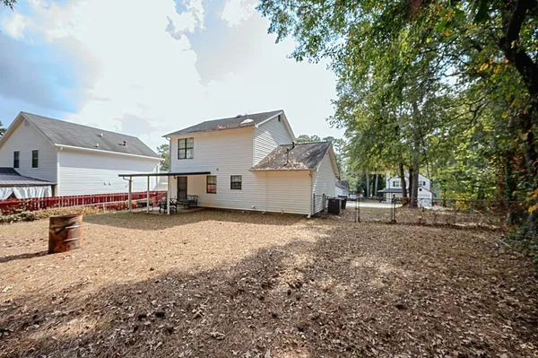 a view of a house with a yard covered in snow