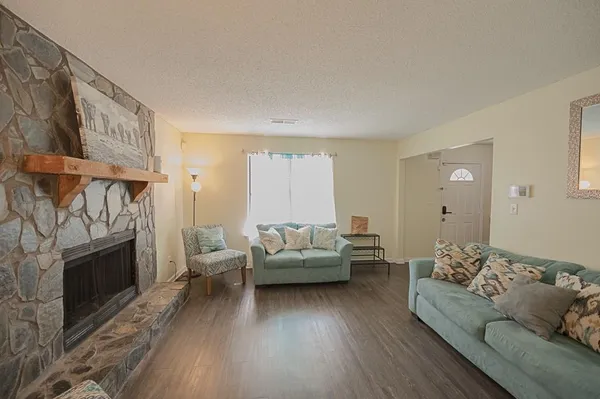a living room with furniture and a fireplace
