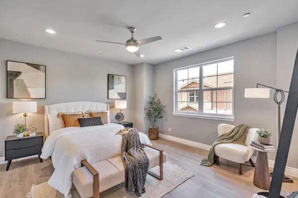 a bedroom with a bed couch and window