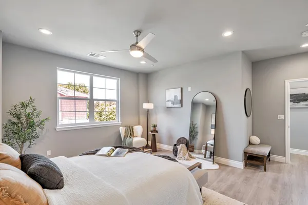 a bedroom with bed or couch and a potted plant