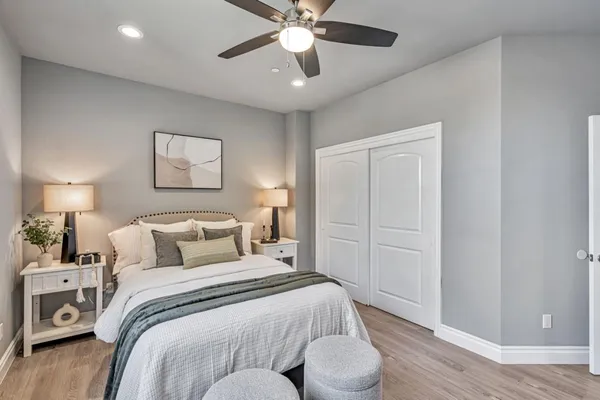 a bedroom with a bed and a chandelier