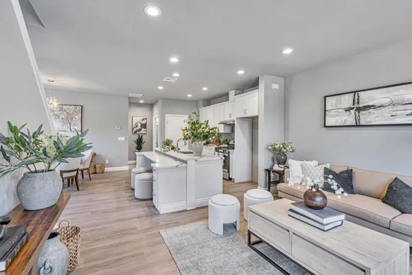 a living room with furniture and flowers