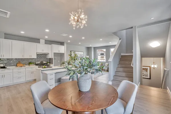 a kitchen with a table and chairs