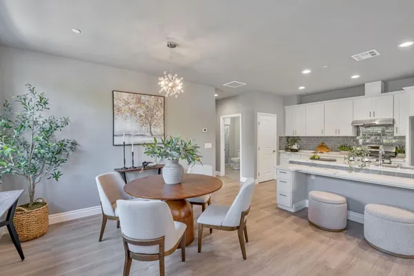 a kitchen with a table and chairs in it