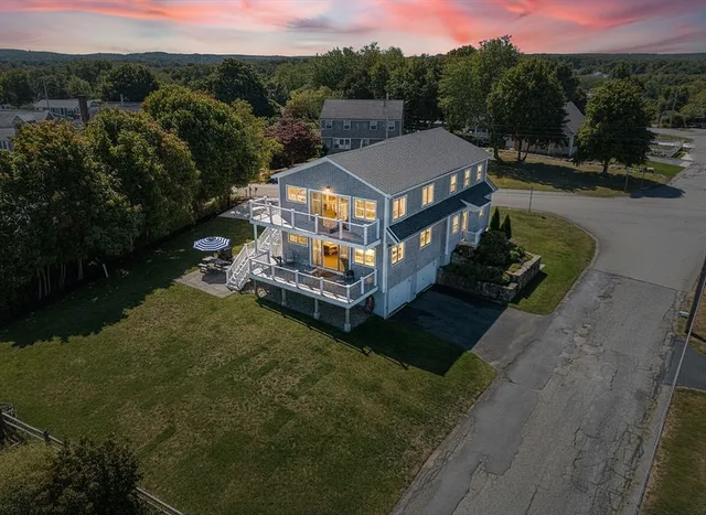 an aerial view of a house with a yard