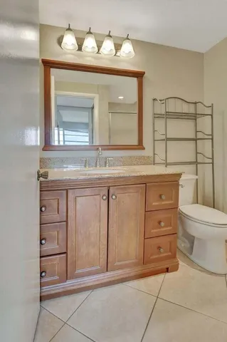 a bathroom with a sink a toilet and mirror
