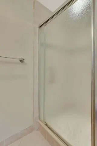a bathroom with a glass shower door