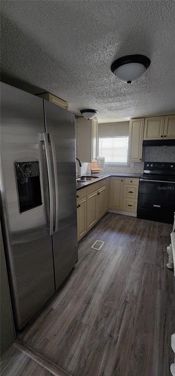 19865 Southwest 5th Place Dunnellon, FL 34431 - Photo 34 of 78 a kitchen with stainless steel appliances granite countertop a refrigerator a stove and a sink