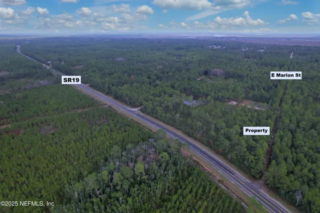 a view of a sign board with garden