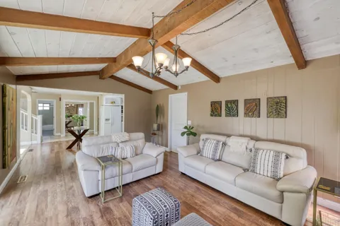 a living room with furniture and a chandelier