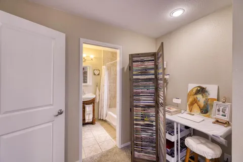 a view of a workspace with furniture and a window