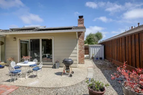 a view of a patio with table and chairs and potted plants