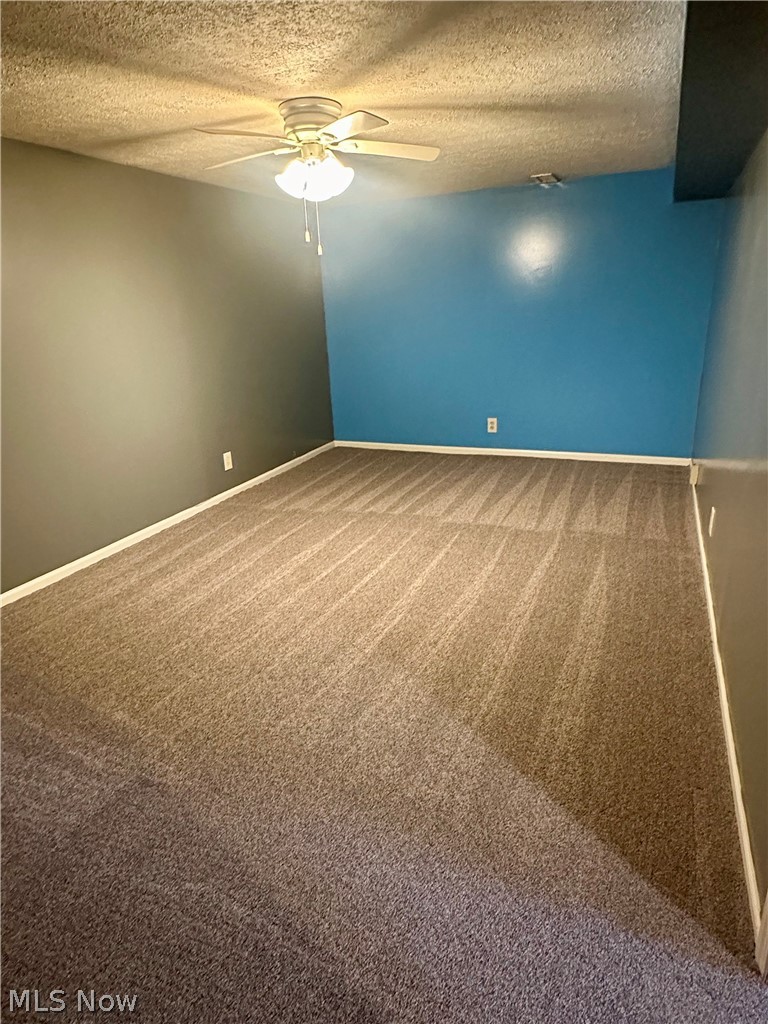 6855 Old Town Road Mount Perry, OH 43760 - Photo 24 of 38 Carpeted spare room featuring ceiling fan and a textured ceiling