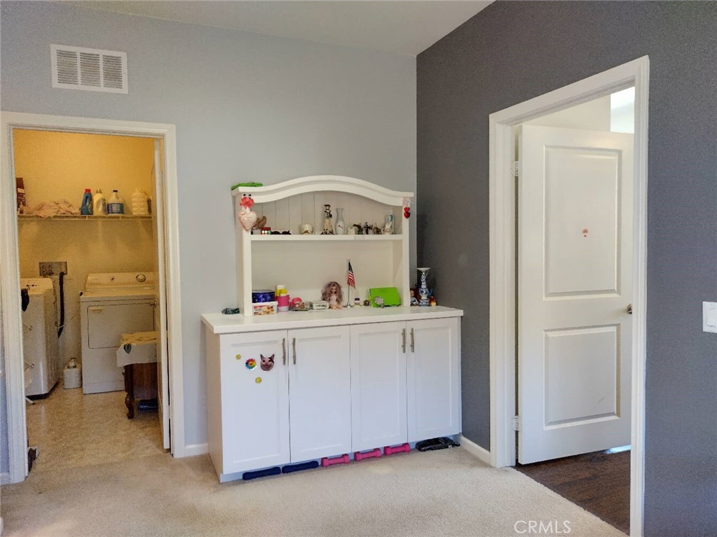 11811 Cramer Road Yucaipa, CA 92399 - Photo 46 of 56 a storage room with washer and dryer