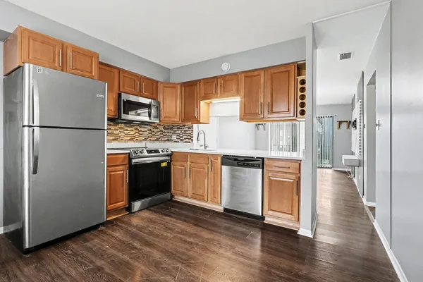 a kitchen with stainless steel appliances a refrigerator sink and cabinets