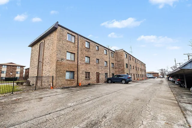 a view of a building the ocean and trees