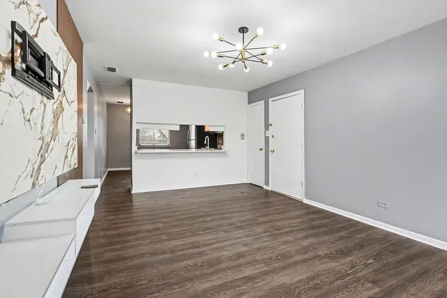 a view of a hallway with wooden floor and a large window