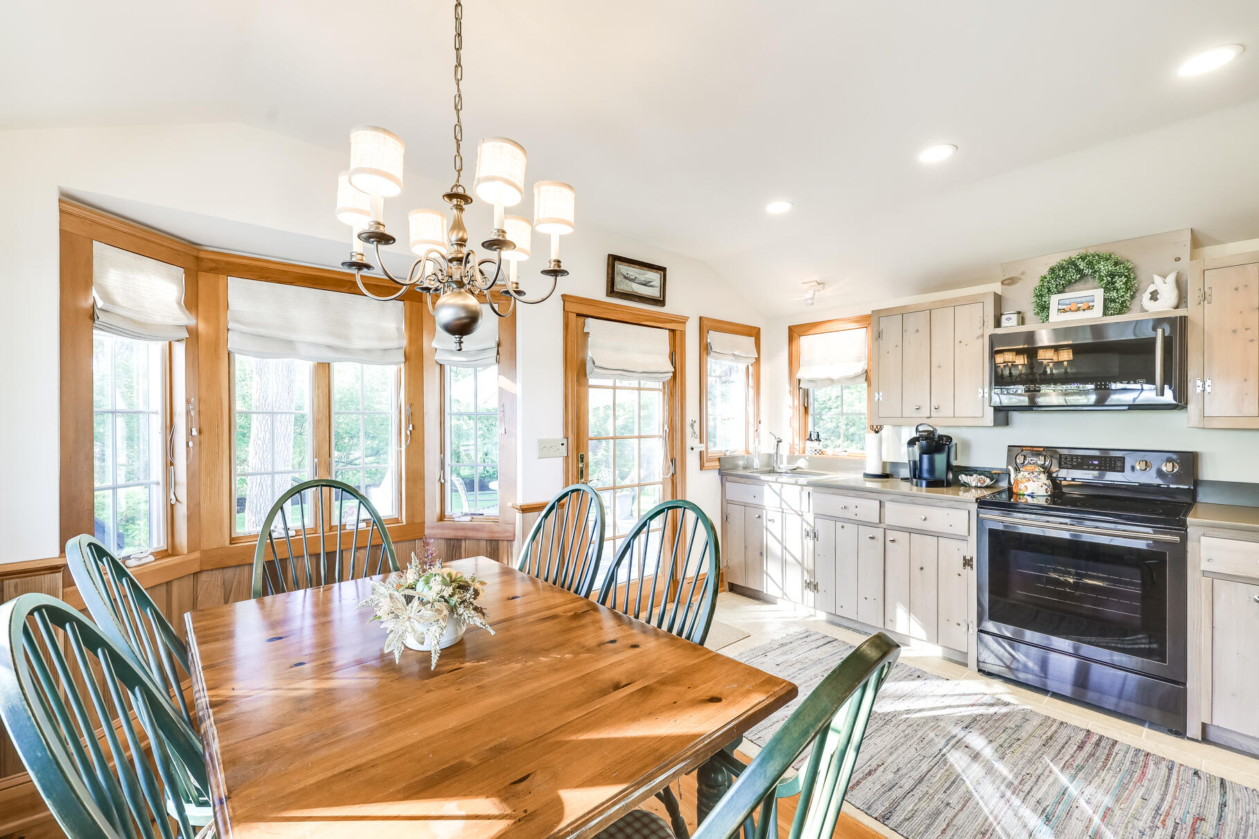 74-75 Viking Road Orleans, MA 02653 - Photo 41 of 69 a view of a dining room with furniture a chandelier and large windows