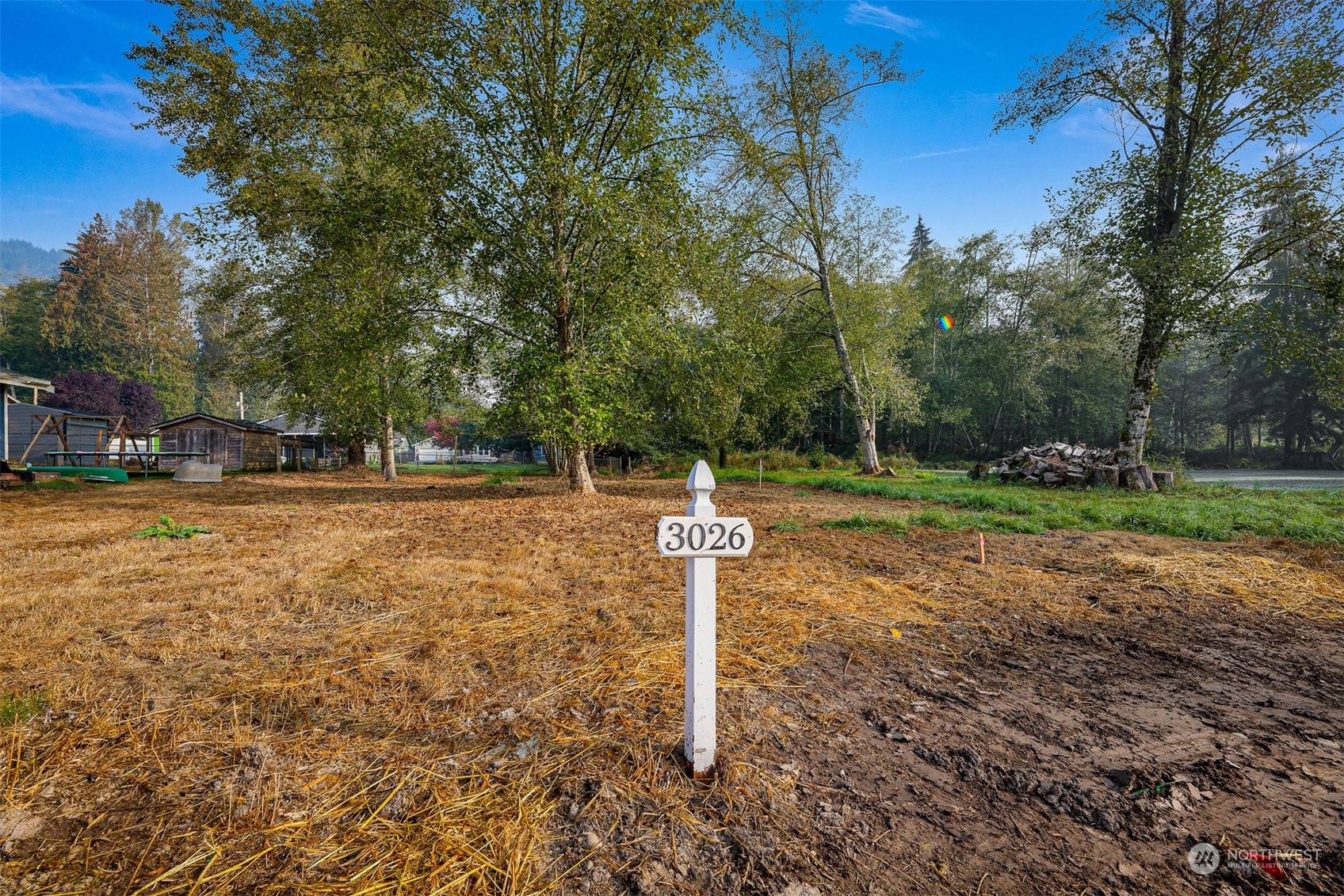 a sign board with yard in the back