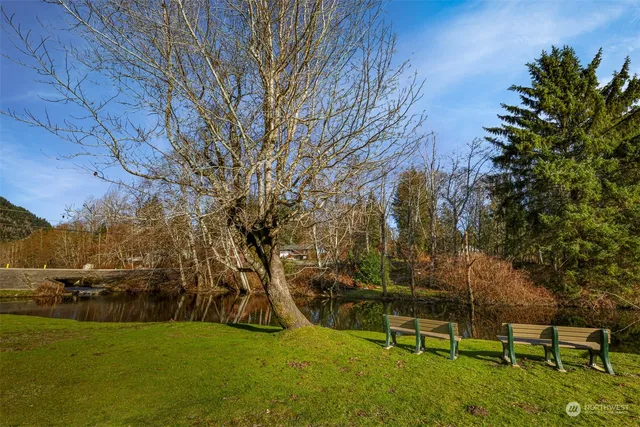 a view of swimming pool with seating area and trees around