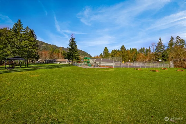 a park with water view and trees in the background