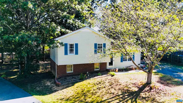 an aerial view of a house with swimming pool garden and patio